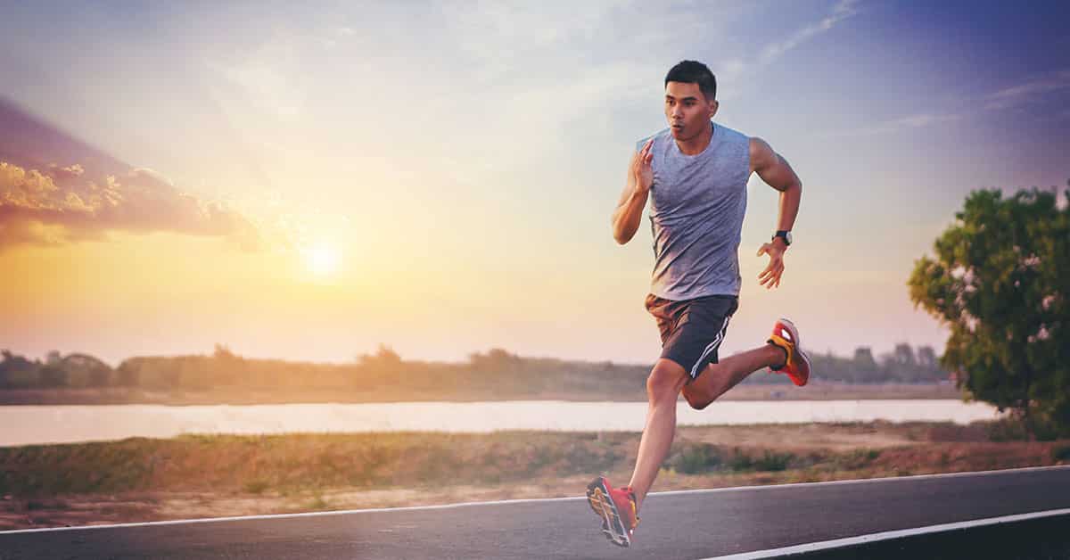 Silhouette of man running sprinting on road. Fit male fitness ru