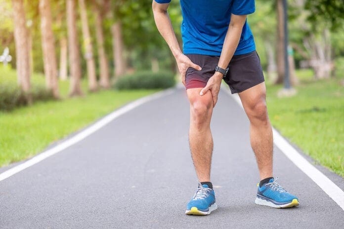 Young adult male with muscle pain during running. runner have le