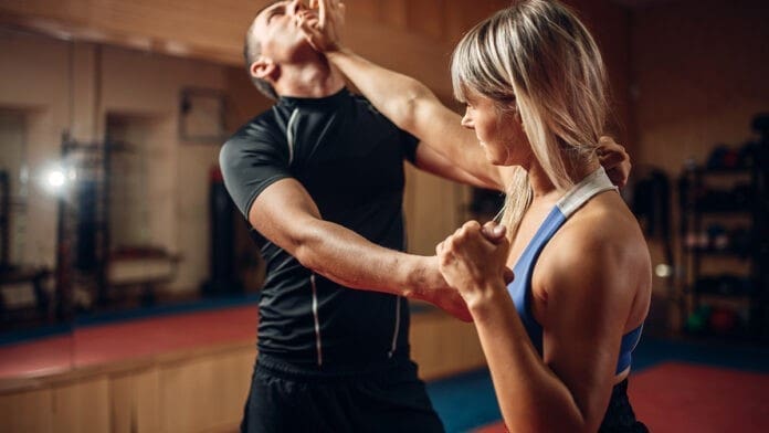 Female person on self-defense workout with trainer